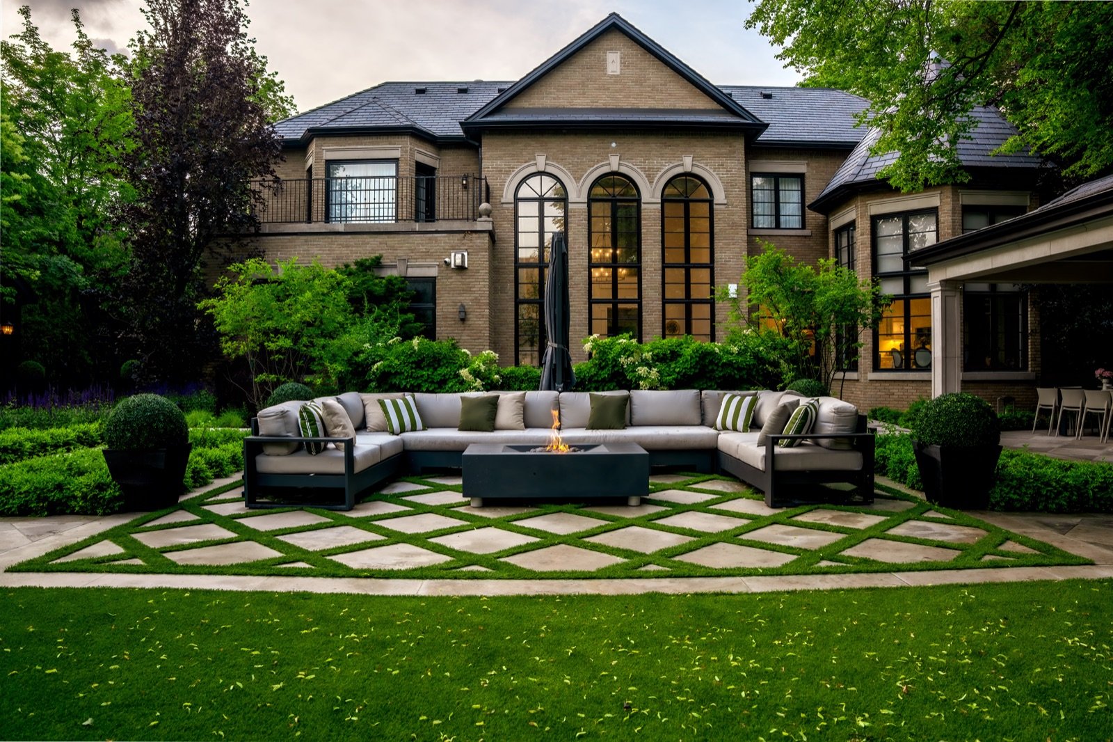 Luxury estate with landscaped garden and outdoor lounge at dusk